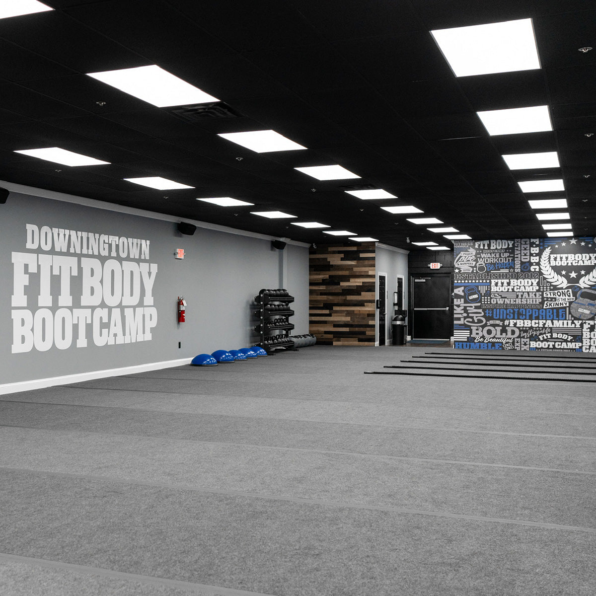 Modern gym interior with bright 2x4 LED Panel – 3 CCT – 25W/35W/45W – MaxLite FlatMax Value lighting on ceiling
