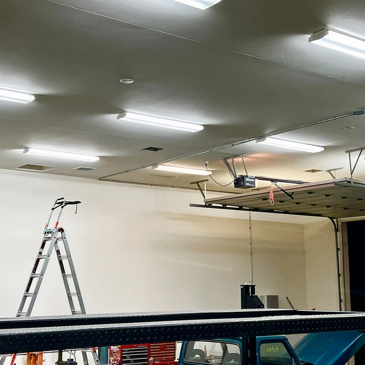 Garage ceiling with multiple bright 4ft LED Tube 5000K 24W Type B lights and a ladder nearby