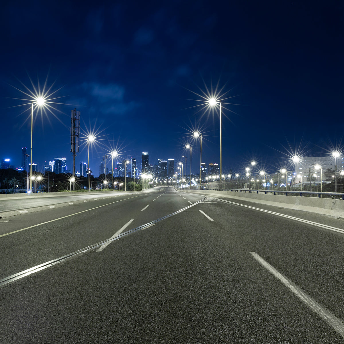 Empty urban road at night illuminated by LED Shoebox Area Light 3 CCT with bright white streetlights