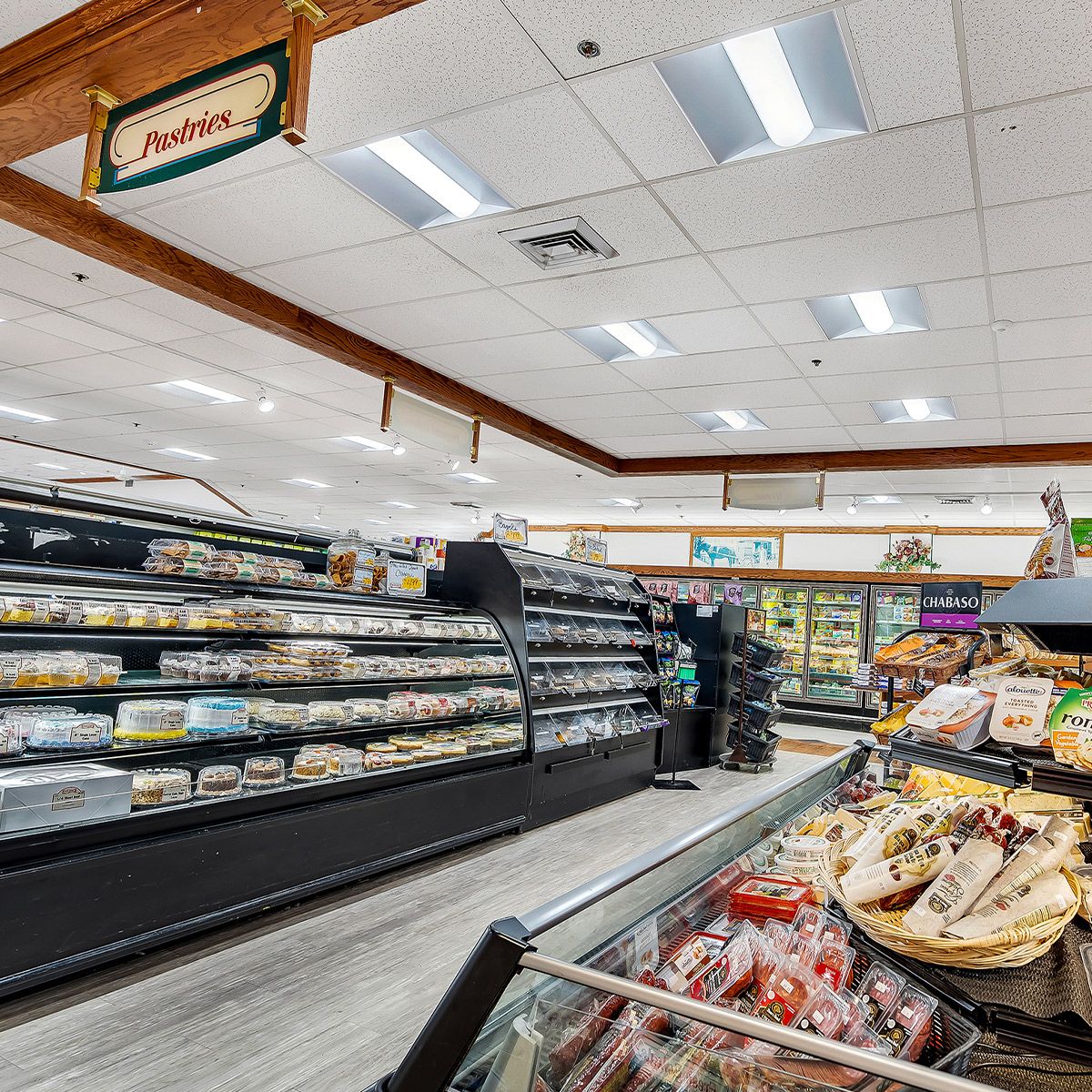 2x4 LED Troffer 3 CCT MaxLite ArcMax installed in a grocery store ceiling illuminating the pastry section evenly