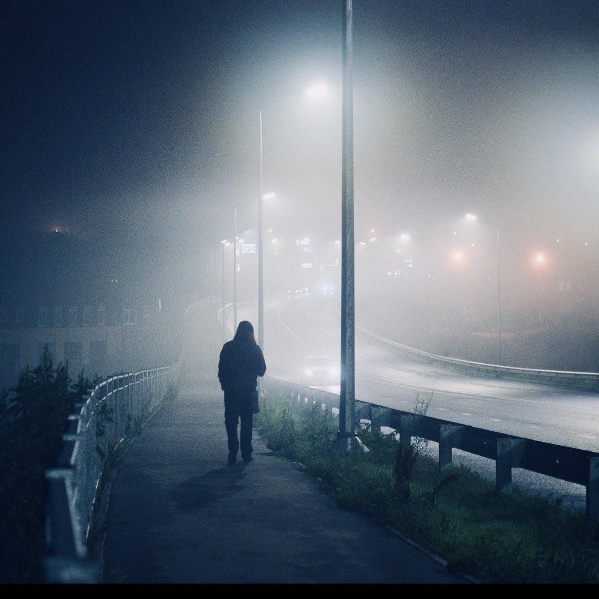 Solar LED Area Light with Tiltable Lenses - 60W illuminating a foggy street with bright, efficient off-grid lighting.