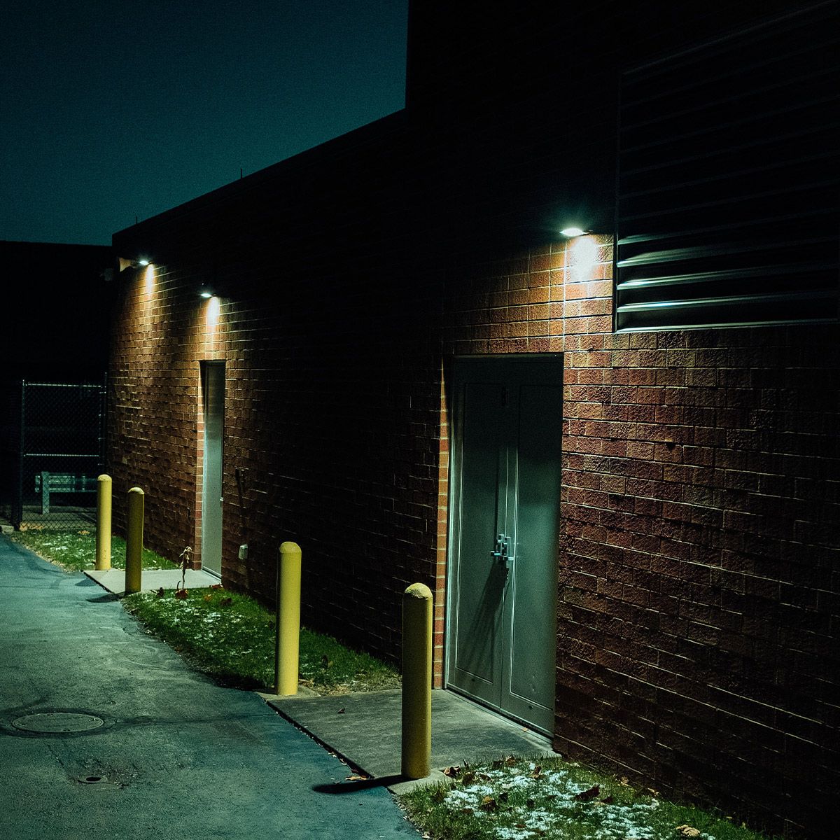 Full Cutoff Angle Adjustable LED Wall Pack 67W illuminating a commercial building exterior at night
