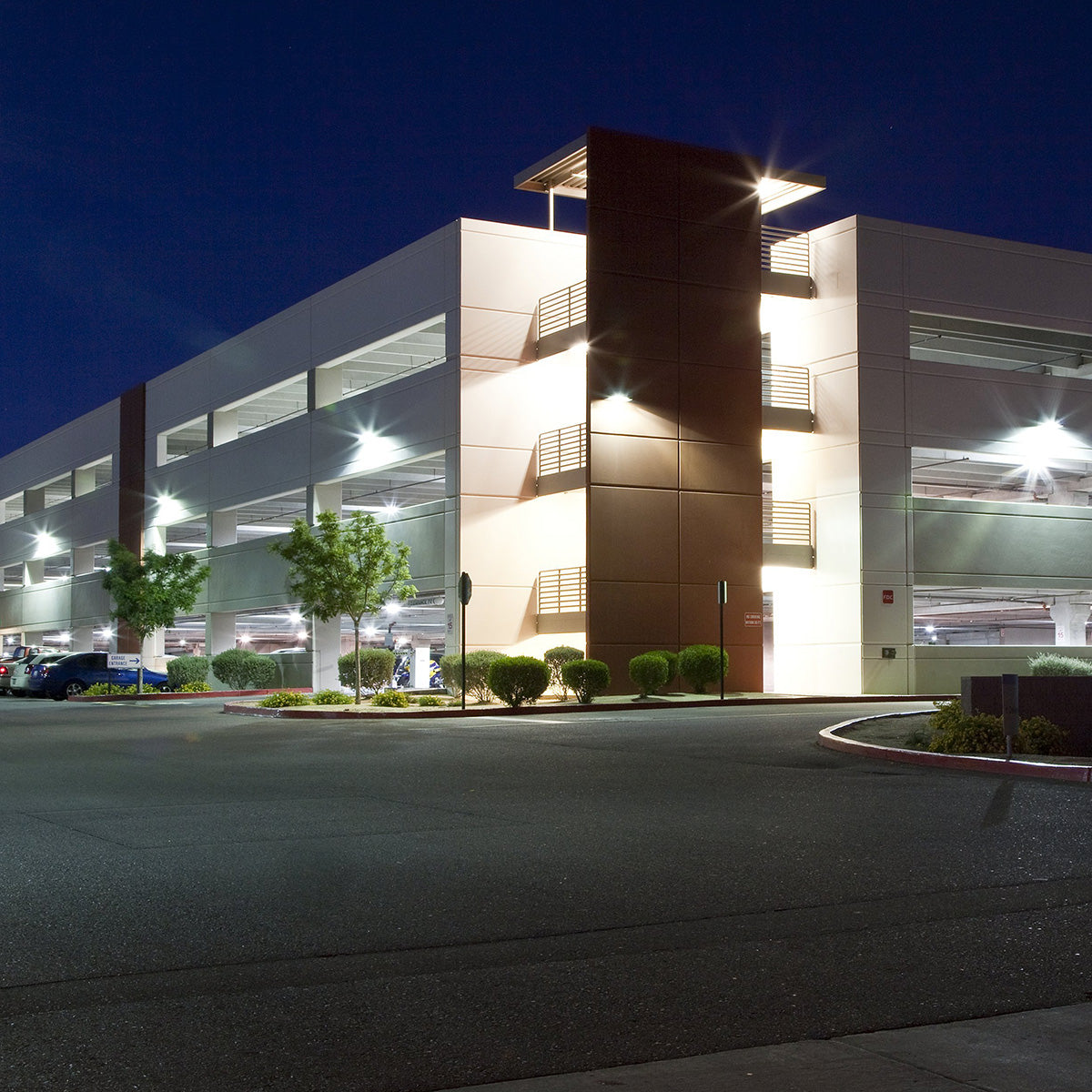 LED Shoebox & Wall Pack Retrofit - E39 - 3 CCT - 80W illuminating a multi-level parking garage at night