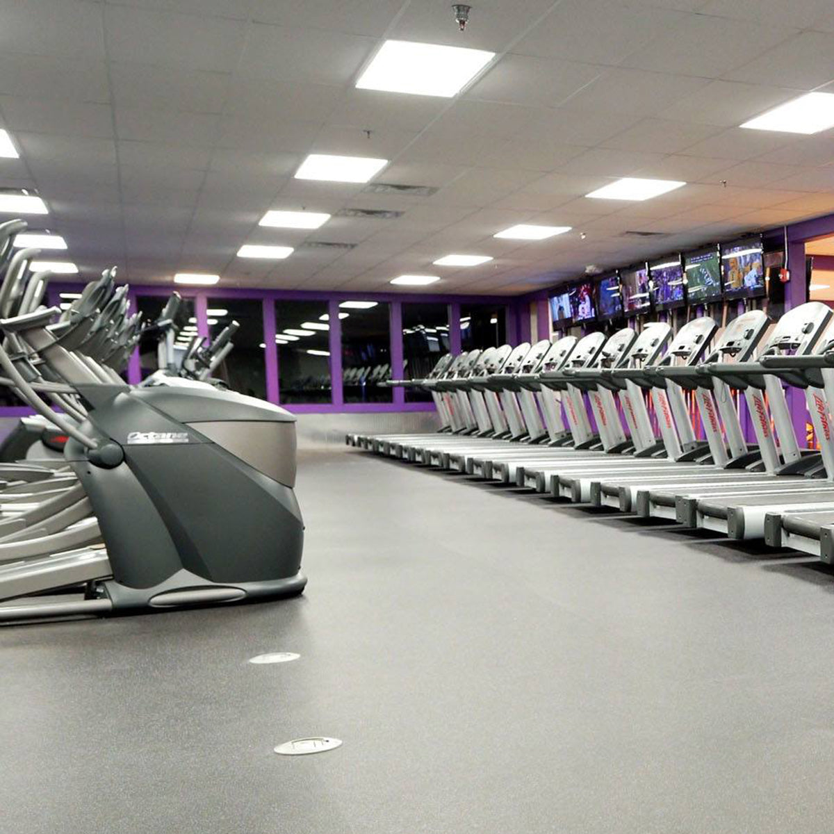 Modern gym interior brightly lit by 2x4 Backlit LED Panel 3 CCT 22W30W38W MaxLite FlatMax Gen5 ceiling lights