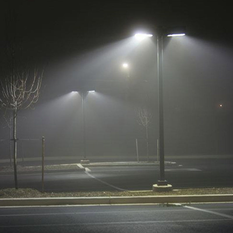 LED Shoebox & Wall Pack Retrofit - E39 - 3 CCT - 110W illuminating empty parking lot at night with bright light beams