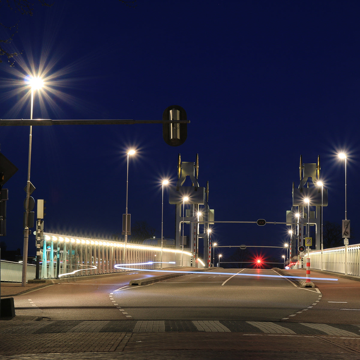 Night street scene illuminated by bright LED Shoebox Area Light 250W fixtures along bridge and road