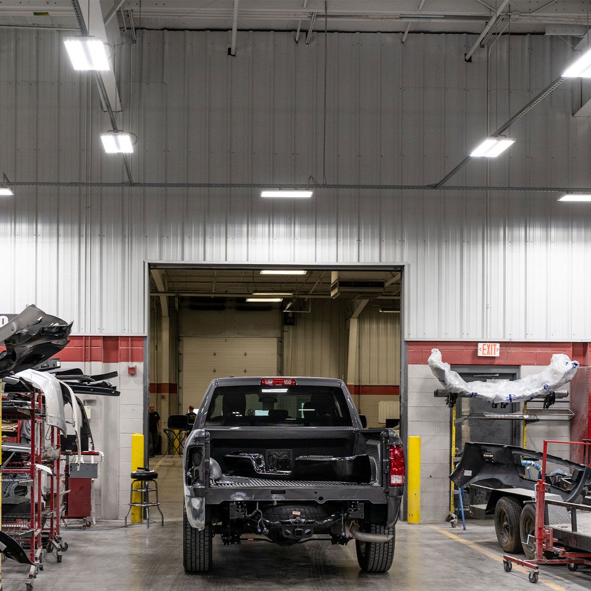 Industrial garage lit by energy-efficient 4ft T5 LED Tube 25W Type B fixtures installed on ceiling