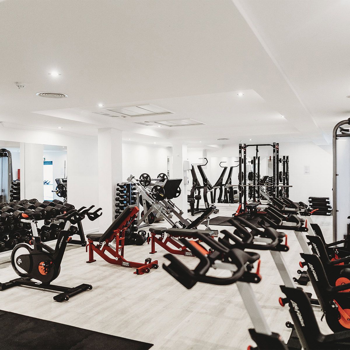 Bright modern gym interior with Germicidal UVC Disinfecting Linear Light fixtures installed on the ceiling