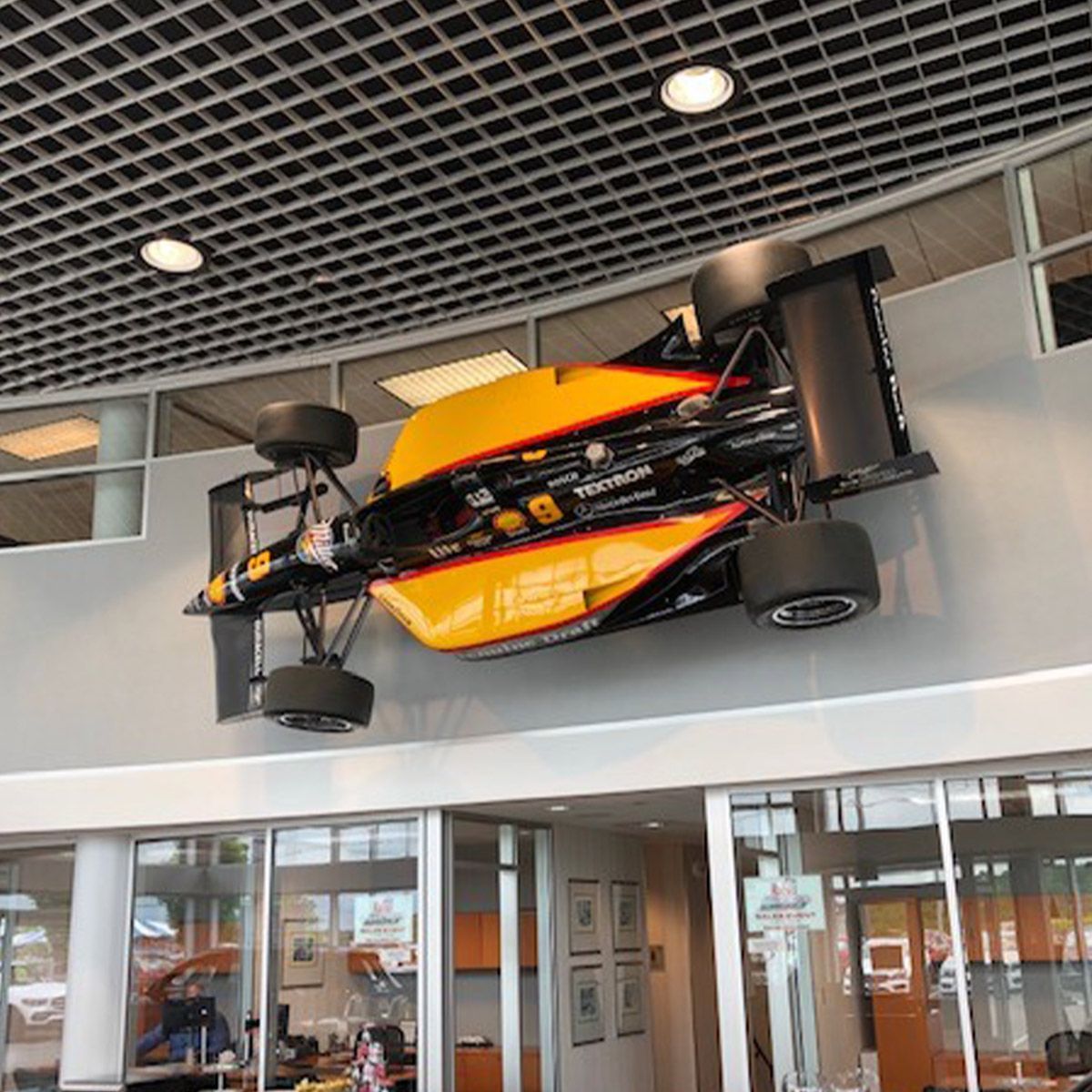 Race car displayed on office wall under industrial ceiling with LED High Bay Retrofit Lamp E39 90W lighting