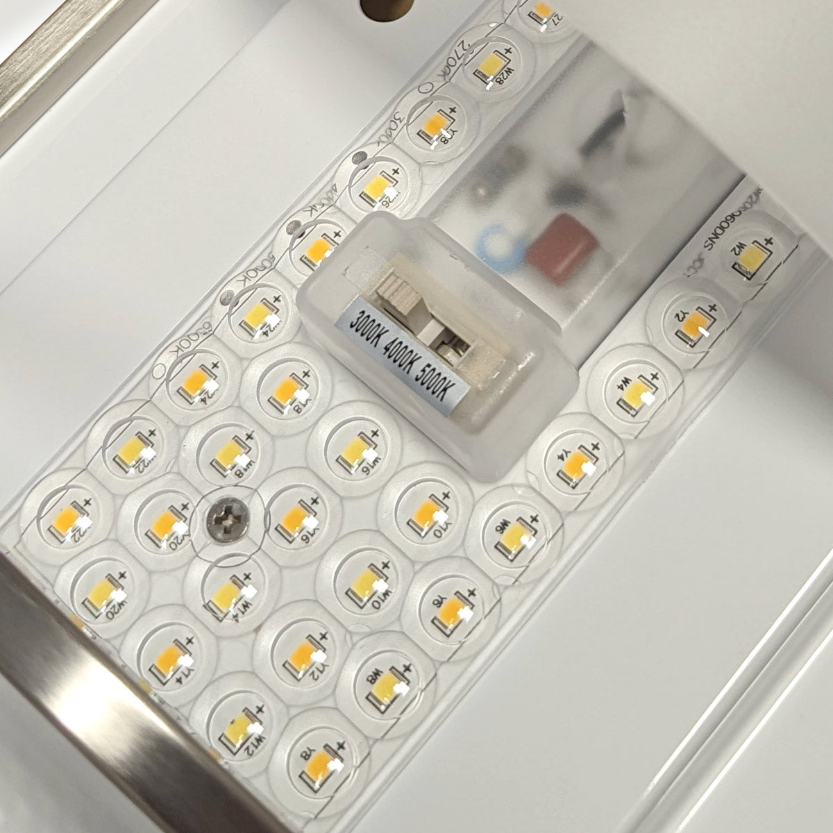 Close-up of LED panel and 3-CCT switch on LED Wall Sconce Brushed Nickel 15W fixture interior components