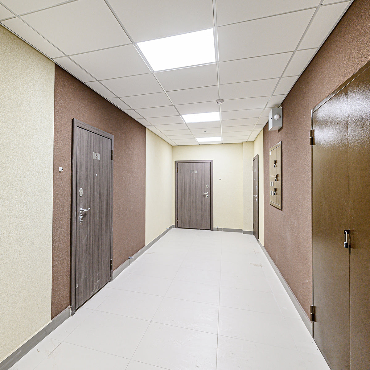 Brightly lit hallway ceiling panels featuring 2ft LED Tube 5 CCT Selectable 8W 10W 12W Type B lights