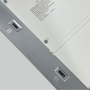 Close-up of a LED light fixture with dip switches for selecting CCT and wattage. 