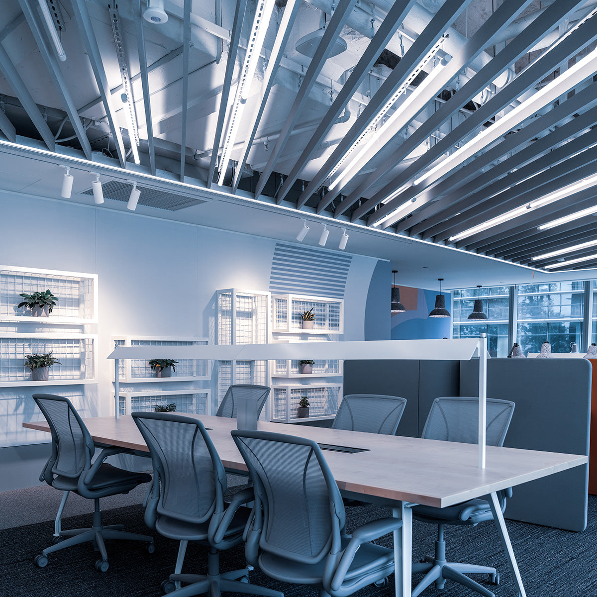 Modern office space illuminated by 4ft LED Tube 5 CCT Selectable 14W 18W 20W Type B lights overhead and on shelves