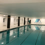 Indoor swimming pool illuminated by 8 Universal High Lumen LED Downlight with adjustable color temperature and wattage settings