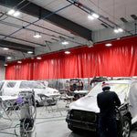 Industrial workshop illuminated by Linear LED Low Bay - 130W fixtures for high-ceiling commercial spaces