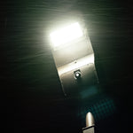 Solar LED Street & Area Light 30W illuminated at night showing bright white light and motion sensor detail