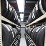 4ft High Bay LED Vapor Tight light fixture illuminating industrial storage room with stacked tires on racks