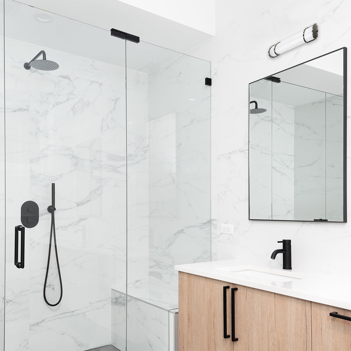 36" LED Vanity Light in brushed nickel above mirror in modern bathroom with glass shower and marble walls
