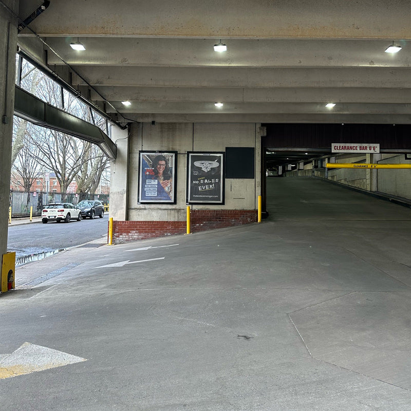 LED Canopy Light 52W MaxLite CPL Series illuminating covered parking garage and driveway area.