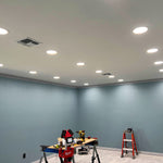 4 Non-Metallic LED Wafer Lights installed in ceiling illuminating a room under construction with tools visible
