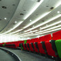 8" Architectural LED Downlight installed in curved ceiling of auditorium with red and green seats