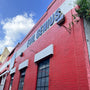 Full Cutoff LED Wall Pack - 3 CCT mounted on red brick commercial building exterior under blue sky