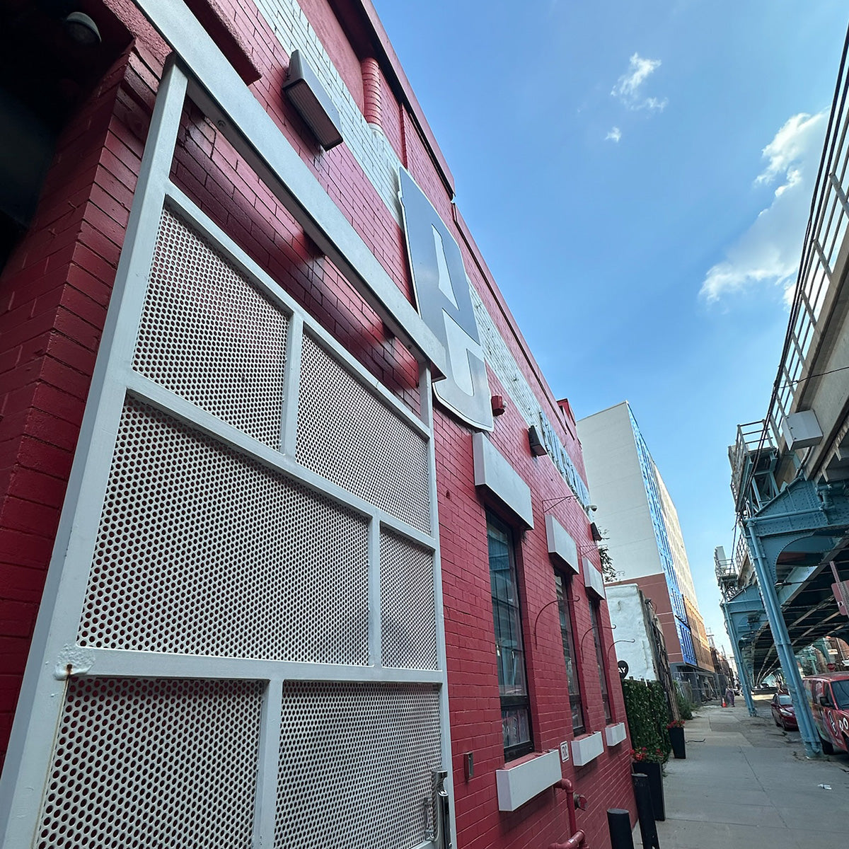 Full Cutoff LED Wall Pack 135W mounted on red brick building providing focused downward lighting at street level