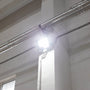LED Flood Light 100W mounted indoors with bright wide-angle beam illuminating ceiling and wall area
