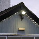 LED Flood Light w/Photocell - 3 CCT - 300/240/180W mounted on outdoor building corner illuminating surroundings at dusk