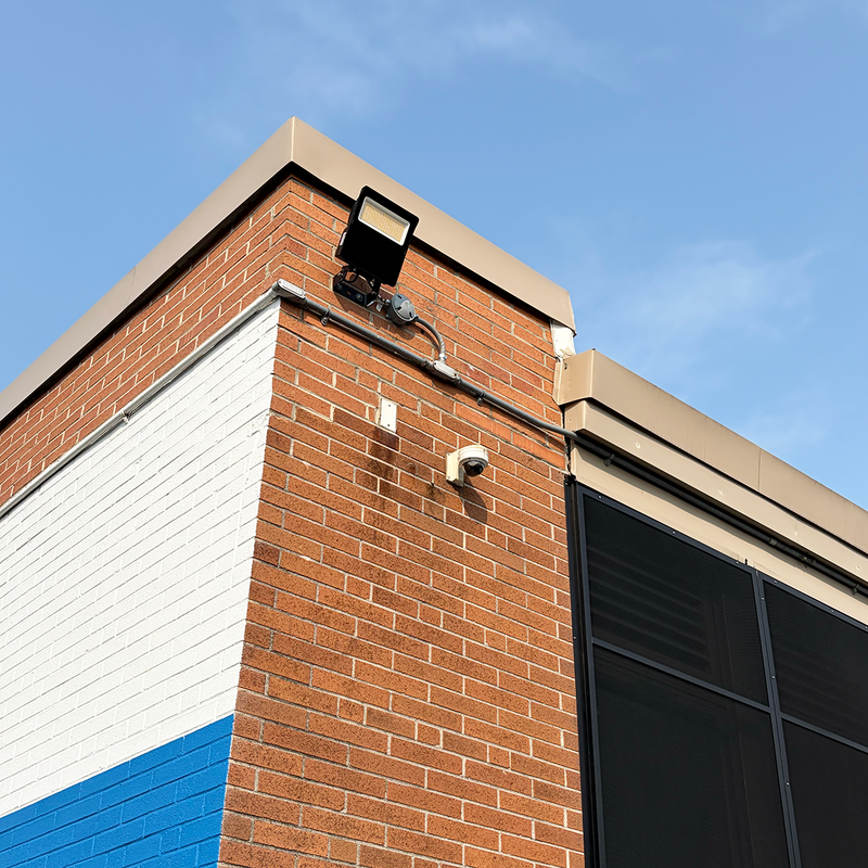 LED flood light installed on brick building