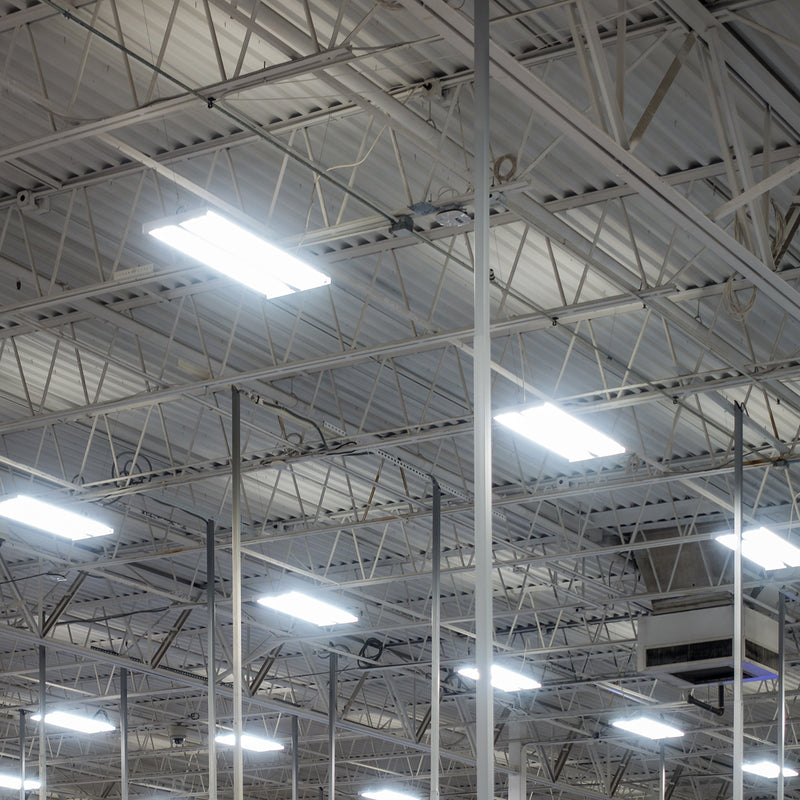 Linear LED High Bay – 300W fixtures lighting a large industrial warehouse with bright, energy-efficient illumination