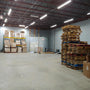 Warehouse lit by 8ft LED Linear Strip Light Linkable 3 CCT 60/70/80W with bright and even illumination