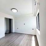 15 Single Ring LED Ceiling Light 5-CCT 22W installed in modern empty room with natural light and wood floor