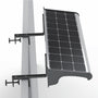 A wall-mounted solar sign light fixture with a black photovoltaic panel, silver metal frame, and black mounting brackets attached to a sign top, shown against a white background.