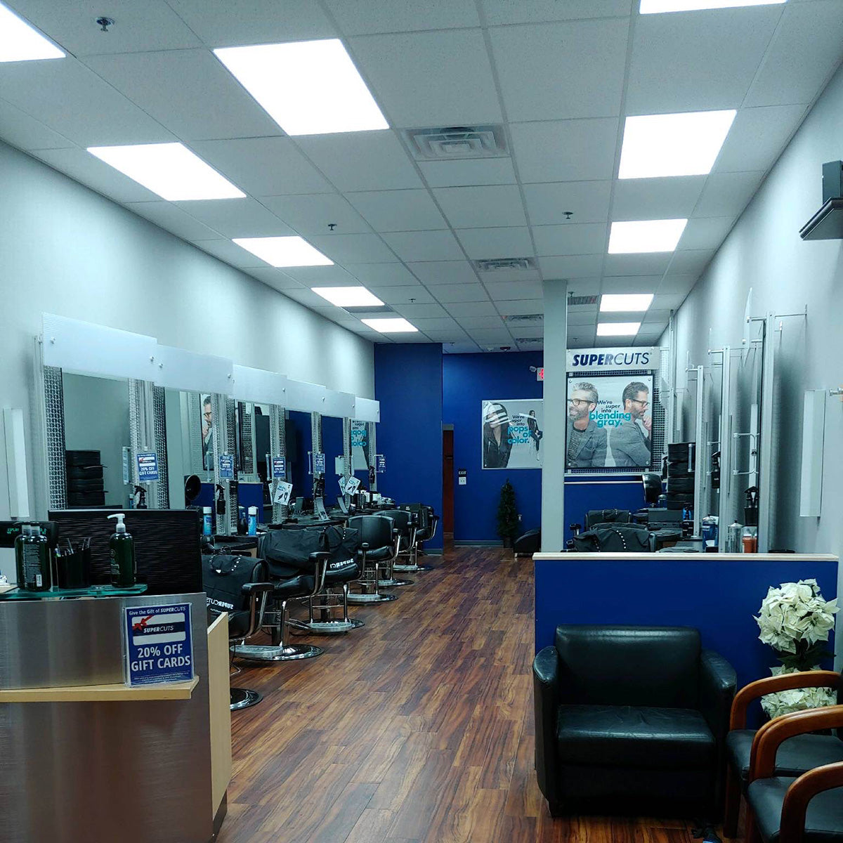 Bright modern salon interior illuminated by 2x4 LED Panel 40W RAB T34 fixtures in drop ceiling