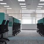Modern office interior lit by 2x2 LED Troffer 3 CCT 18/25/30W RAB SWISH34 lights with workstations and chairs