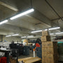 8ft LED Vapor Tight industrial lighting installed in a storage area with stacked boxes and equipment
