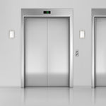 LED Wall Sconce brushed nickel with opal acrylic shade installed beside elevator doors in modern setting