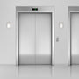 LED Wall Sconce brushed nickel with opal acrylic shade installed beside elevator doors in modern setting