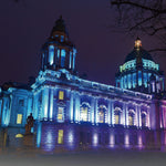 Historic building facade illuminated with vibrant blue and purple hues using RGBW LED linear wall washer light