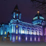 Historic building facade illuminated with vibrant blue and purple hues using RGBW LED linear wall washer light