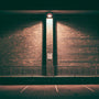 Full Cutoff LED Wall Pack - 3 CCT - 100/80/60/40W illuminating a brick wall with focused downward light