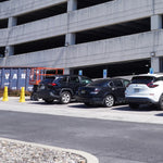 Semi Cutoff LED Wall Pack - 3CCT installed lighting a parking garage exterior in daylight settings