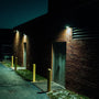 Full Cutoff Angle Adjustable LED Wall Pack 67W illuminating a commercial building exterior at night