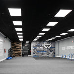 2x4 Backlit LED Panel – 3 CCT – 22W/30W/38W lights installed in a spacious indoor training facility ceiling.