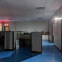 LED Exit Sign & Emergency Light Combo illuminating exit and workspace in low light office environment