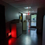LED Exit Sign glowing brightly in a dim hallway, ensuring safe and visible emergency exit guidance.