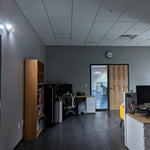 Dual Head LED Emergency Light mounted in an office corner illuminating the room during a power outage.