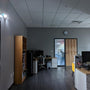 Dual Head LED Emergency Light mounted in an office corner illuminating the room during a power outage.