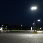 LED Shoebox Area Light 150W illuminating a large outdoor parking area at night with bright, even lighting.